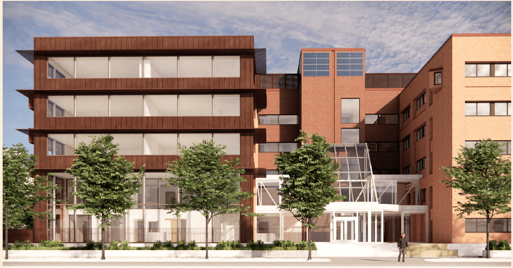 Framifrånvy av modern skolbyggnad i tegel med stora fönster och glasad huvudentré, omgiven av träd och planteringar.