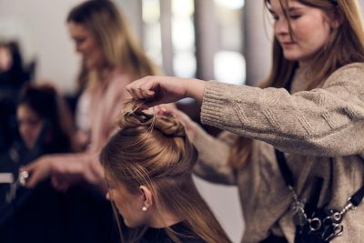 Elev stylar en kunds hår