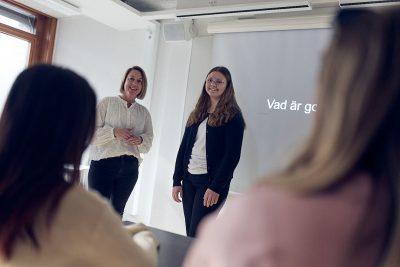 Elev och lärare framför en klass