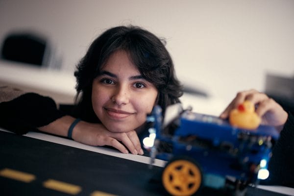 Elev som jobbar med en maskin med en anka ovanpå